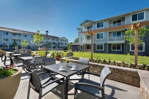 Outdoor seating area with tables and chairs
