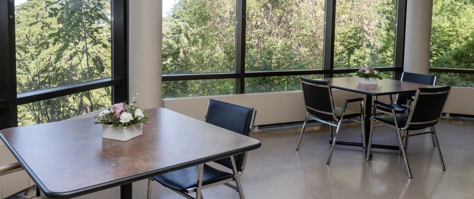 Bright common area with tables and outdoor view
