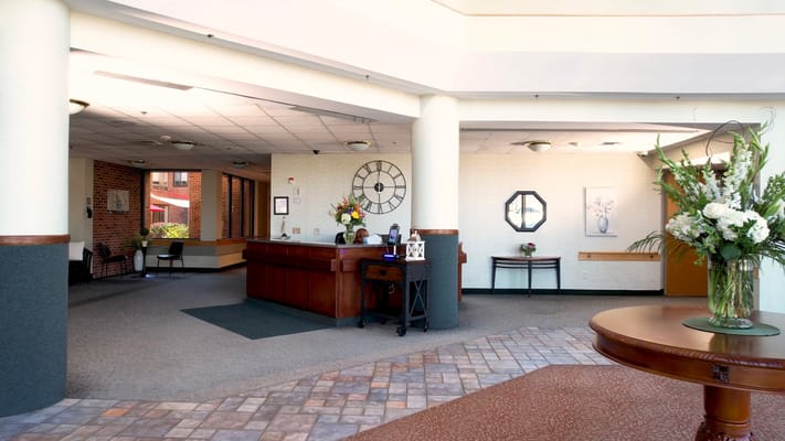 Bright lobby area with reception desk and seating