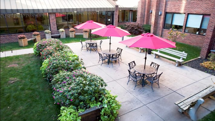 Outdoors area with tables and umbrellas in a garden