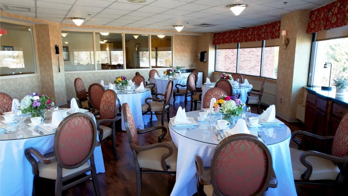 Dining room set for a meal with flowers and tableware