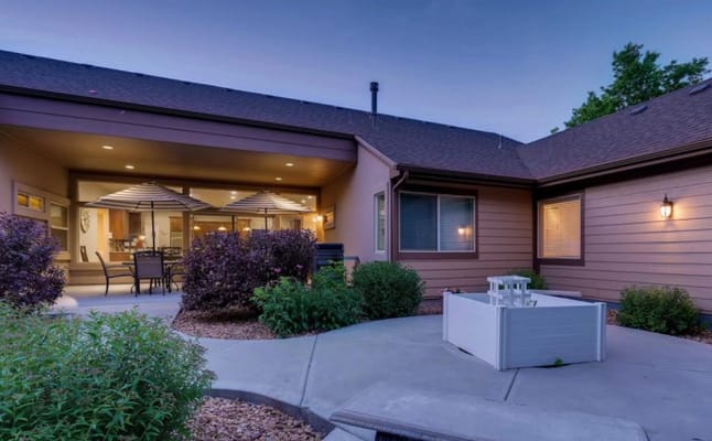 Outdoor patio area with seating and landscaping