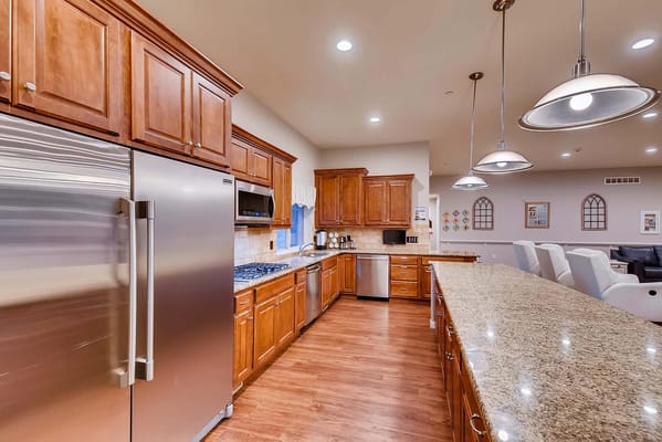 Bright kitchen space with wooden cabinetry and granite countertops