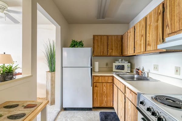 Bright kitchen area with wooden cabinets