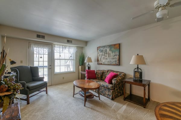 Cozy living area with floral seating and lamps