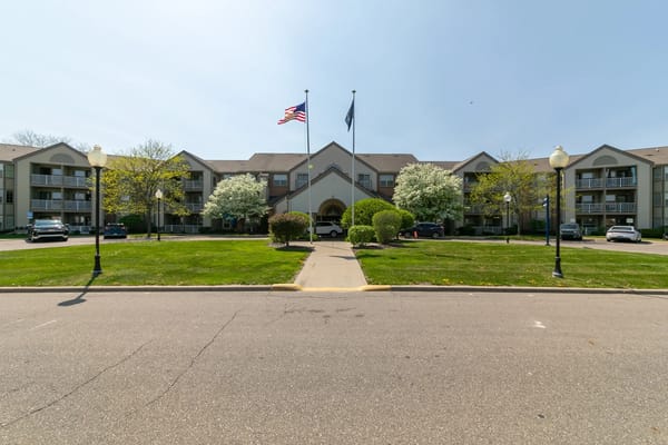 Exterior view of Rosehaven Manor with landscaped entrance