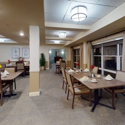Dining room set for a meal with floral centerpieces