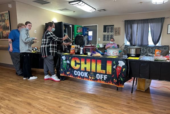 Residents participating in a chili cook-off event in the dining area.