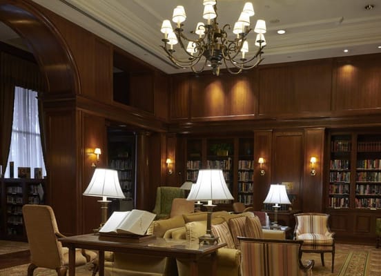 Warm wooden library with bookshelves and comfortable seating