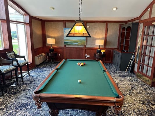 A pool table set up for a game in a retirement community lounge.