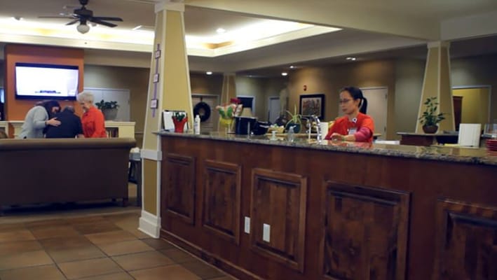 Reception area with staff and residents in the lobby of Seashore Highlands