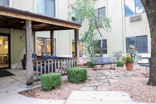 Outdoor patio area with benches and garden