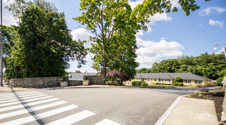 Entrance view with trees and sign at Capitol Ridge at Providence