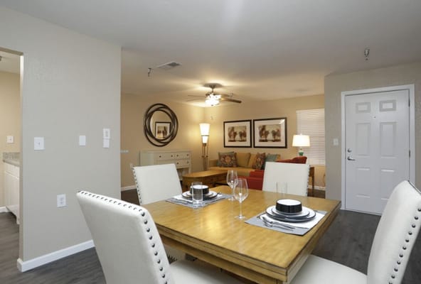 Brightly lit common area with dining table and living space