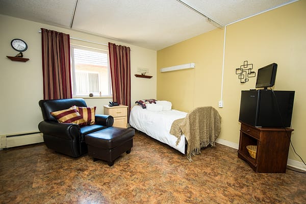 Interior of a private resident room with furniture