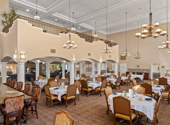 Spacious dining area with tables set for residents