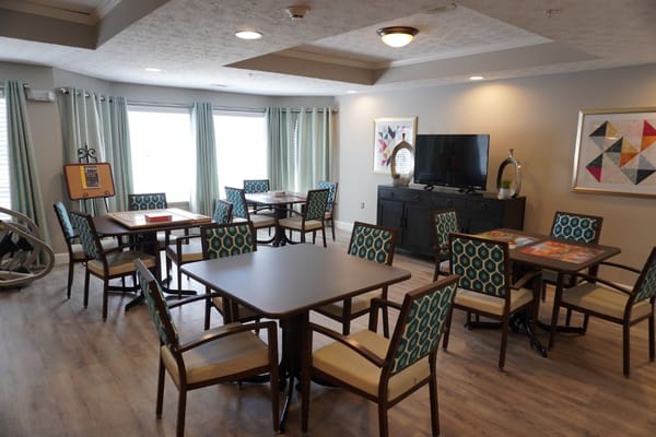 Spacious community room with tables and chairs