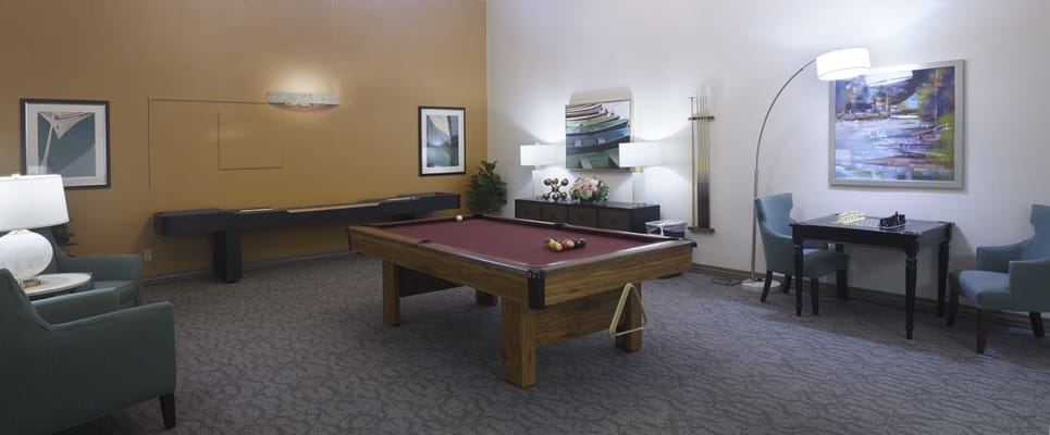 Bright common area with billiard table and seating