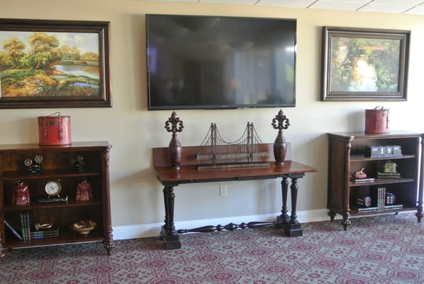 A decorated living room with a TV and elegant furnishings.