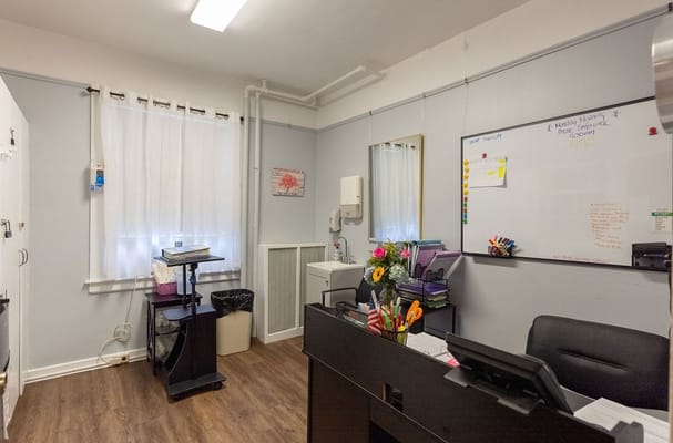 Clean office space with desk and flowers