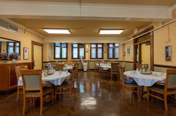 Bright dining area with tables set for residents