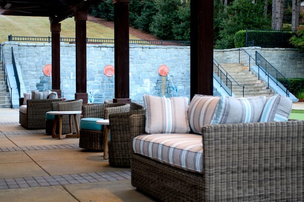 Outdoor seating area with wicker chairs and tables