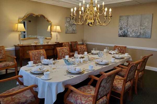 Elegant dining room setup with a chandelier and floral decor