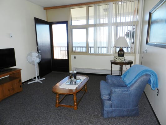 Cozy living room with a chair, table, and TV
