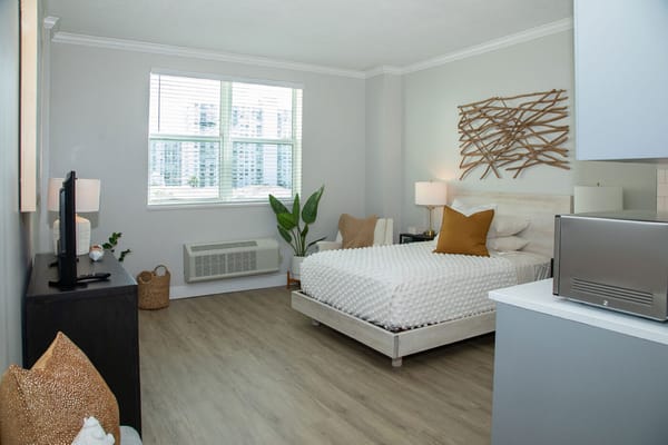 Bright, modern resident room with cozy décor