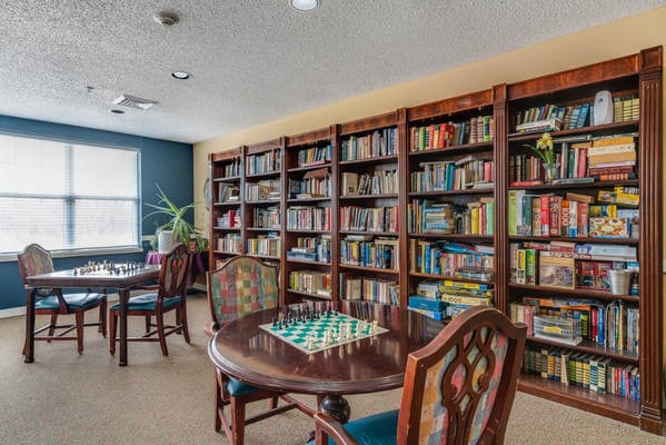 Cozy common area with bookshelves and chess tables