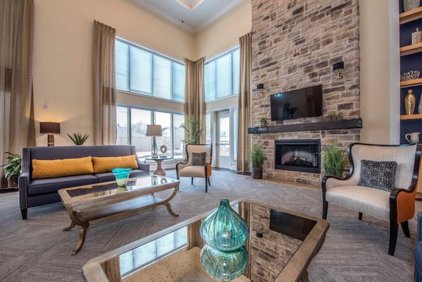 Cozy lounge with a stone fireplace and large windows