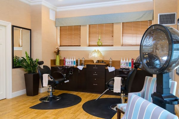 A bright and modern beauty salon with styling chairs