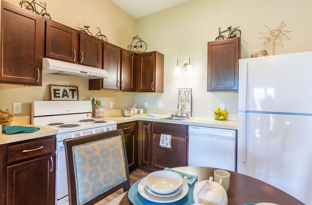 Bright kitchen with wooden cabinets and appliances