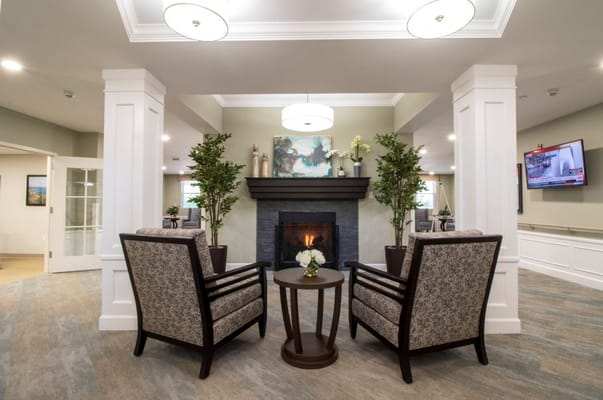 Cozy common area with chairs and a fireplace