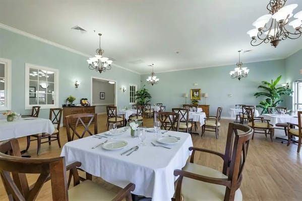 Bright dining room with tables set for meals