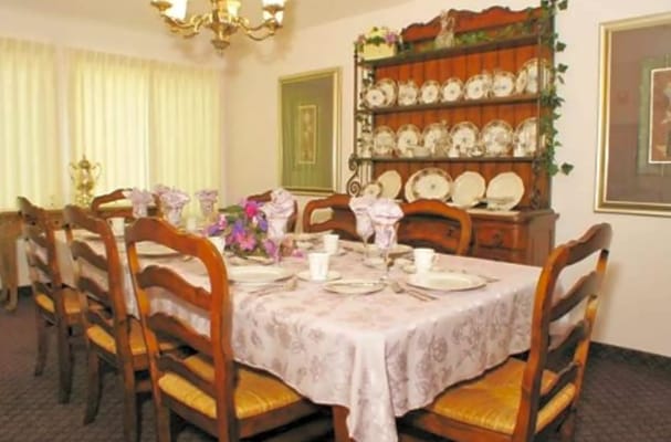 Elegant dining room set with floral decor and tableware