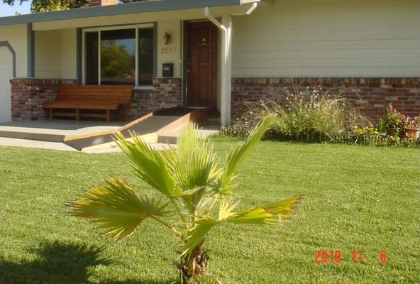 Front exterior of a senior living facility with lawn