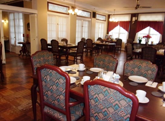 Cozy dining room with tables set for meals
