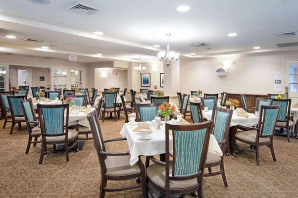 Dining area set for a meal with floral centerpieces