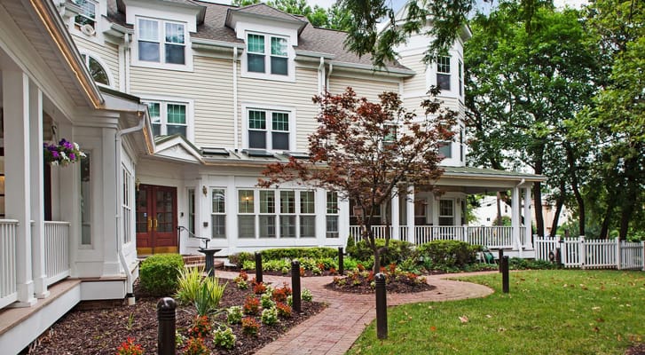Exterior view of a senior living facility with garden