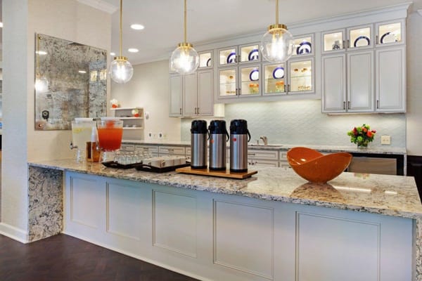 Beverage station with glass pitchers, mugs, and decor