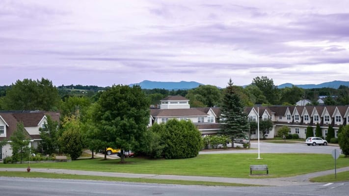 View of Taft Farms Senior Living Community with lush greenery and mountains in the background