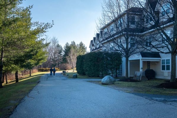 Two residents walking along a scenic path by the facility