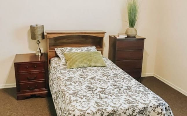 Cozy private room with bed and furniture