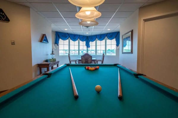 Billiard table in a well-lit common area