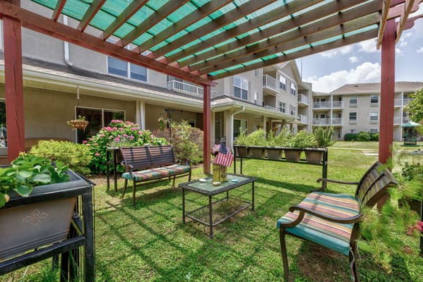 Outdoor seating area with flowers and American flag