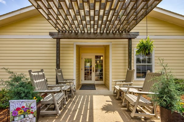 Entrance to a senior living facility with outdoor seating