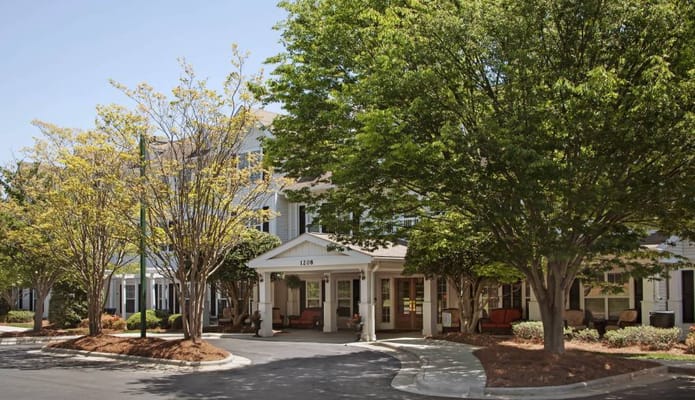 Entrance of a senior living facility with trees
