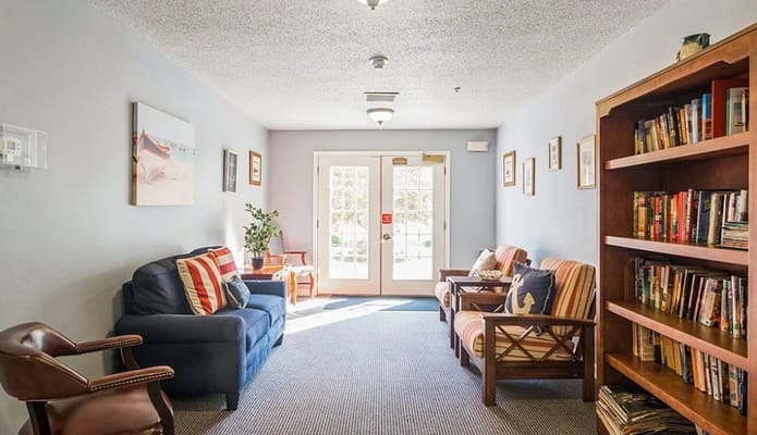 Bright common area with seating and bookshelves