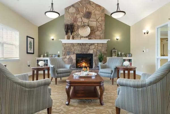 Cozy common area with a stone fireplace and seating